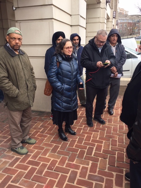 Bhairavi Desai (in the center), executive director of the New York Taxi Workers Alliance stands outside of the NCUA speaking with reporters on Thursday, Feb. 20, 2020. 