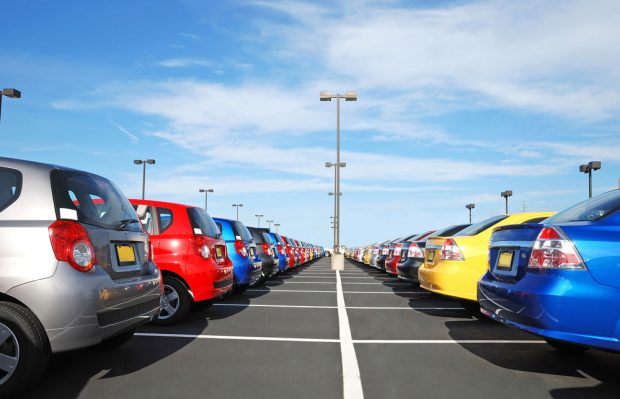 Line of used cars at an auto dealership.