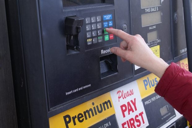 woman paying at the gas pump