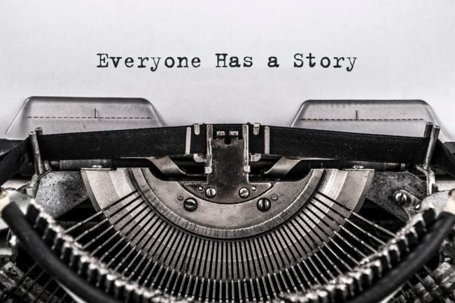 Typewriter with "everyone has a story" text
