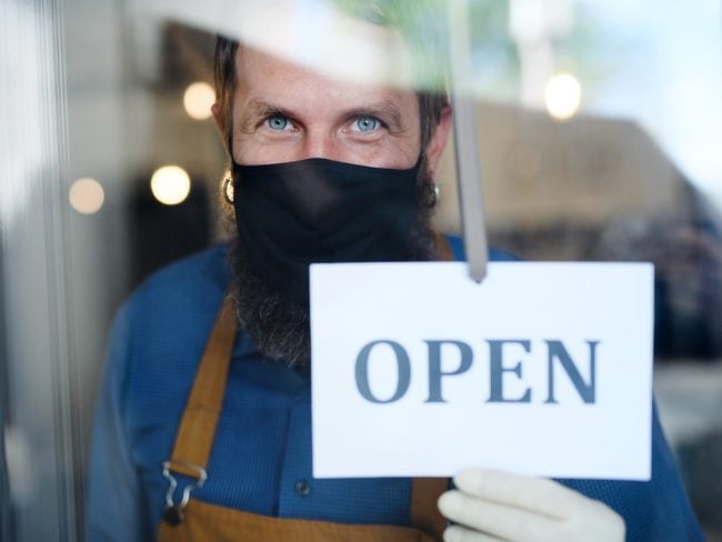 Business owner wearing mask and gloves