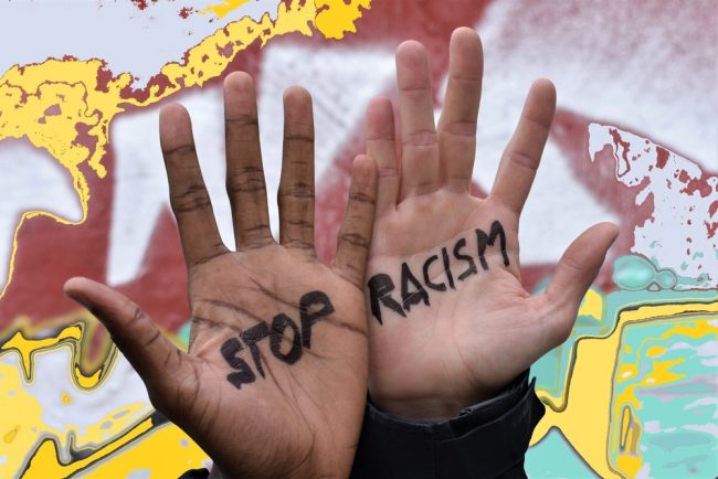 Black and white hands with stop racism writing