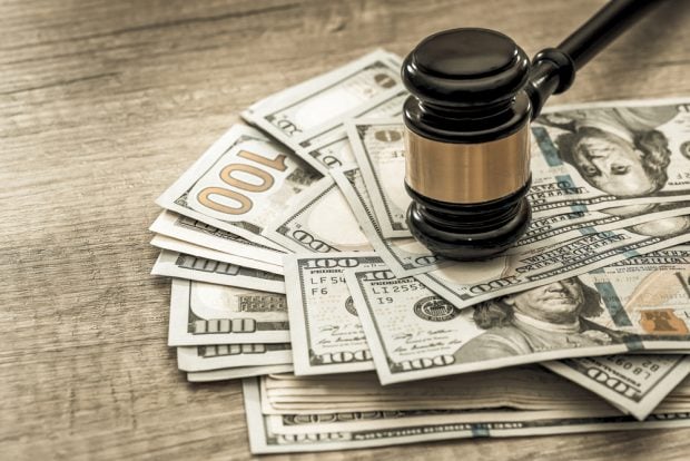 pile of cash under a judge's gavel