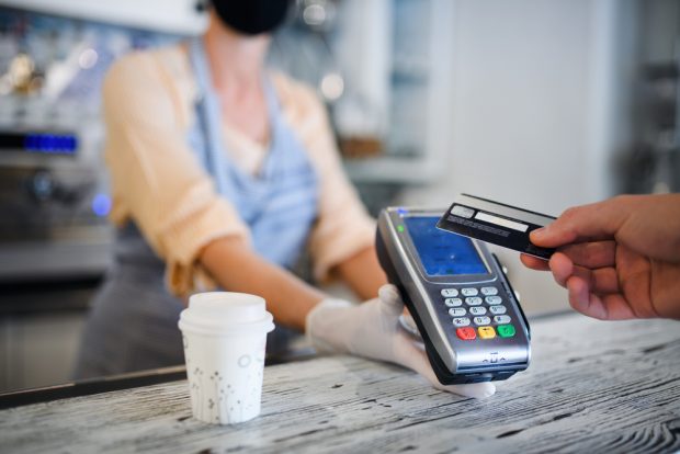 contactless payment with credit card at a coffee shop