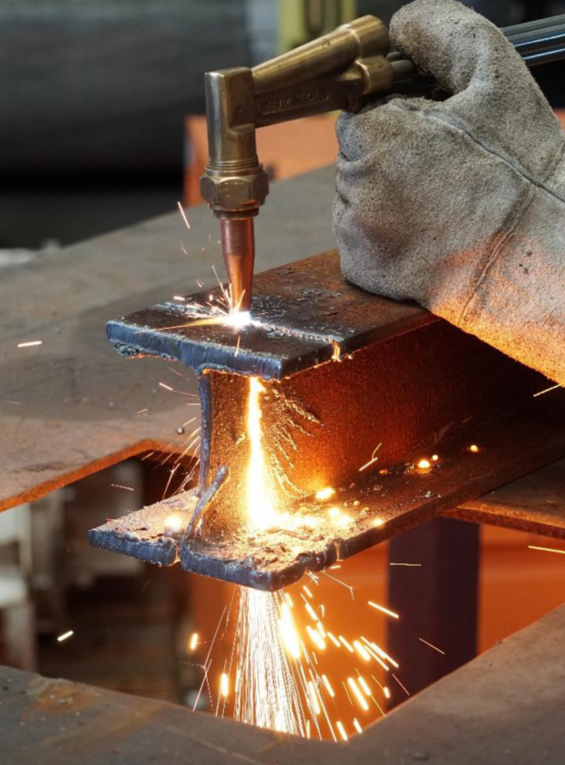piece of steel being cut by welding torch