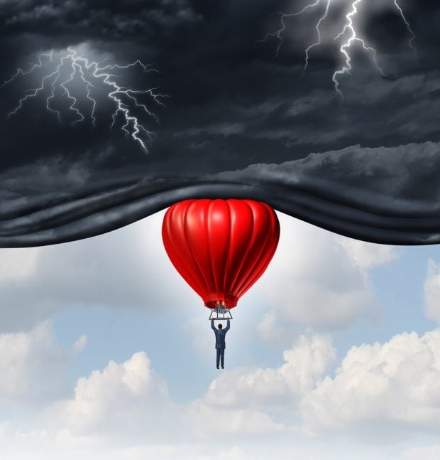 economy as a red balloon floating up into stormy skies 