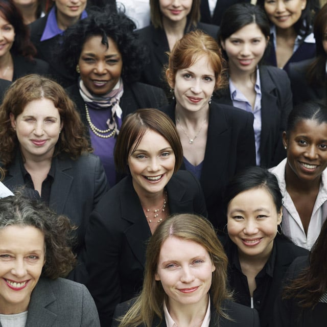 A group of professional women looking into the camera.