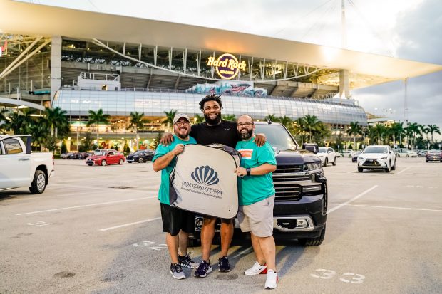 Dade County FCU's Sr. VP of, Marketing and IT Mauricio Morales, Miami Dolphins DE Christian Wilkins, Dade County FCU's Daymar Salgado. (Source: Miami Dolphins)