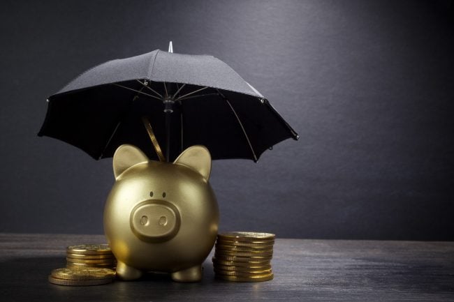 Gold Piggy bank with umbrella concept for finance insurance, protection, safe investment