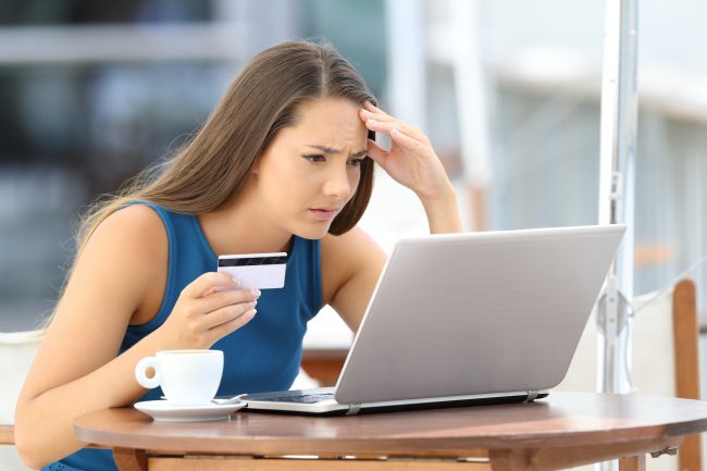 Worried shopper paying with credit card