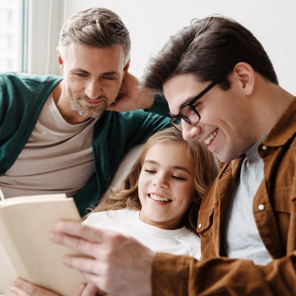 gay couple reading to daughter