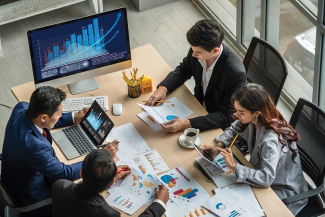 executives around table analyzing data