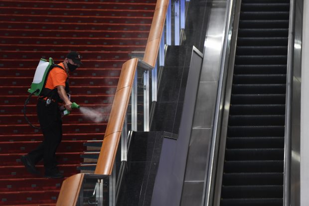 Employee disinfecting stair railings in the Walter E. Washington Convention Center. (Photo: EventsDC)