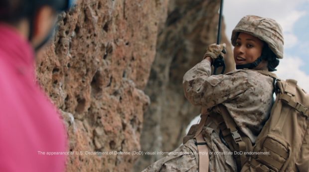 Image from new PenFed ad showing a person in military uniform rapelling down a mountain..