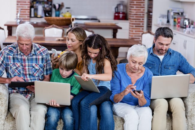 Multi-generation family using a laptop, tablet and phone