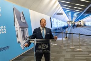 PenFed Credit Union President/CEO and PenFed Foundation President, James Schenck unveils The PenFed Tunnel, a Marketing Campaign Take Over of Concourse C Connector at Washington Dulles International Airport (Source: Clear Channel Outdoor Holdings).