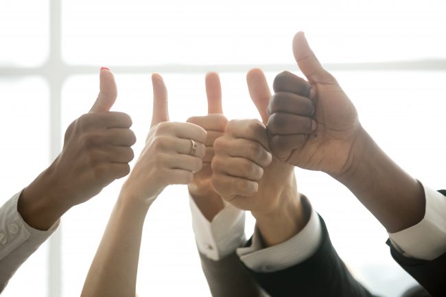 Hands of diverse business team people showing thumbs up