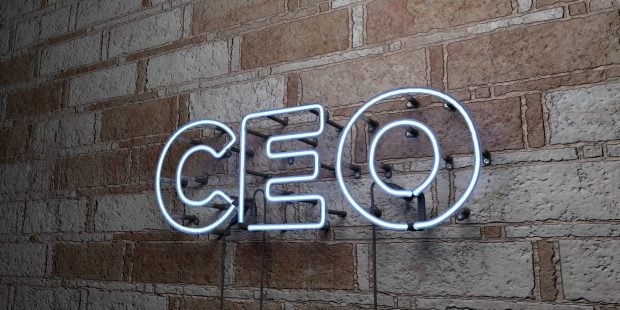CEO - Glowing Neon Sign on stonework wall.