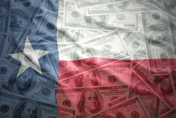 colorful waving texas state flag on a american dollar money background