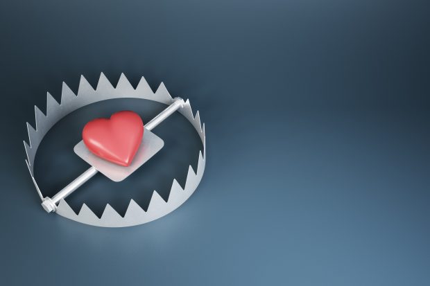 Heart trap concept with red heart in metallic trap on dark background with copyspace. 3D rendering, mockup