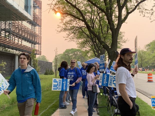 Union employees picket in front of the TruStage headquarters in Madison, Wis on May 19, 2023 (Source: CU Times).