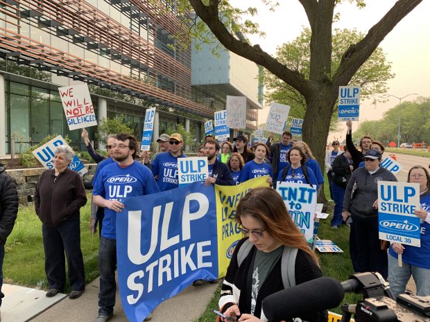 Union employees of TruStage picket outside of the headquarters in Madison, Wis. on May 19, 2023.