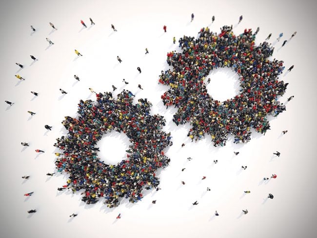 crowds of people forming two gear shapes