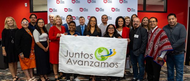 Officials from UW Credit Union and Inclusiv hold the Juntos Avanzamos flag. Thursday, Sept. 7, 2023\. Credit/UW Credit Union