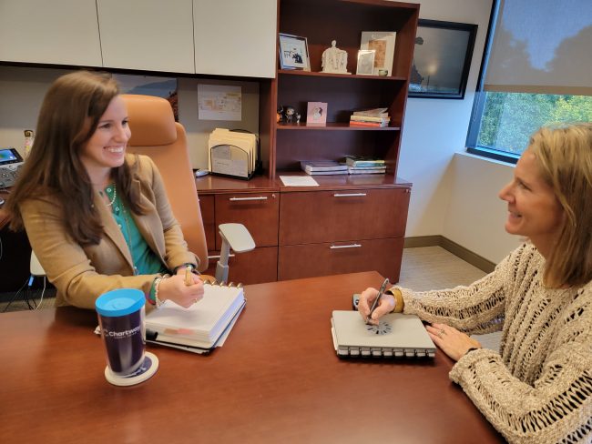Melissa Moffa (left) consults with a colleague in her office at Chartway CU's headquarters in Virginia Beach, Va.
