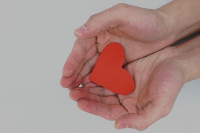 hands holding heart kindness