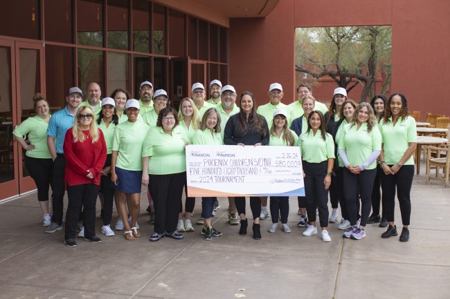 The Desert Financial Foundation presents a check for the $580,000 raised during its recent golf tournamen