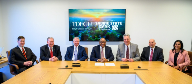 Photo: TDECU signs definitive agreement for the acquisition of Sabine State Bank and Trust. From L to R: Paul Sklar, Chief Financial Officer of Sabine State Bank and Trust; Lee McCann, President and CEO of Sabine State Bank and Trust; Dave Sikora, TDECU Board Chairman; Isaac Johnson, TDECU President and CEO; Jim Cole, Sabine Board Chairman; John Whitehead, General Counsel and Chief Compliance Officer of Sabine State Bank and Trust; Aparna Dave, TDECU Chief Legal Officer and General Counsel Photo courtesy: TDECU
