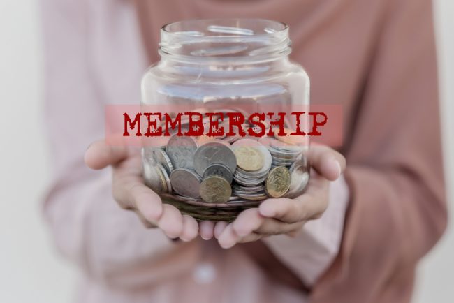 hands holding jar of coins with 