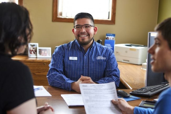 Jose Villa meets with credit union members at his desk