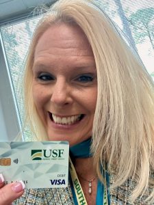 Juli Lewis with her new debit card the day she became a USF FCU member