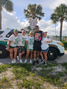 Lewis (center) collaborates with USF students and police for a local pride parade