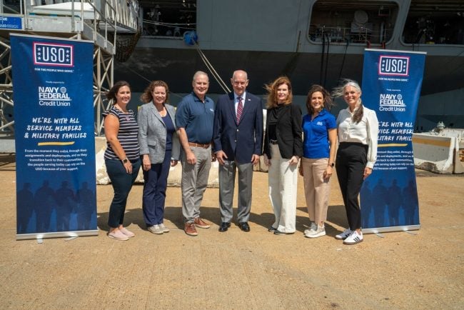 USO and Navy Federal representatives, including Navy Federal President/CEO Dietrich Kuhlmann (third from left), USO President/CEO J.D. Crouch (center) Navy Federal COO Kara Cardona (third from right), attend at a ribbon-cutting on Sept. 12 for the USO's newest ship-based Center aboard the USS Truman, which is currently docked in Norfolk, Va.