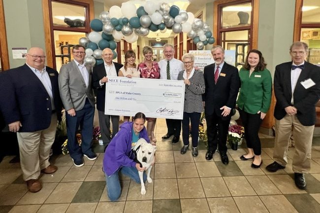 SPCA Wake President/CEO Kim Janzen (center) surrounded by SPCA Wake and SECU Foundation board members