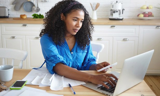 woman with laptop and calculator